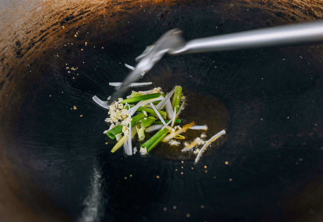 white parts of scallions and garlic in wok
