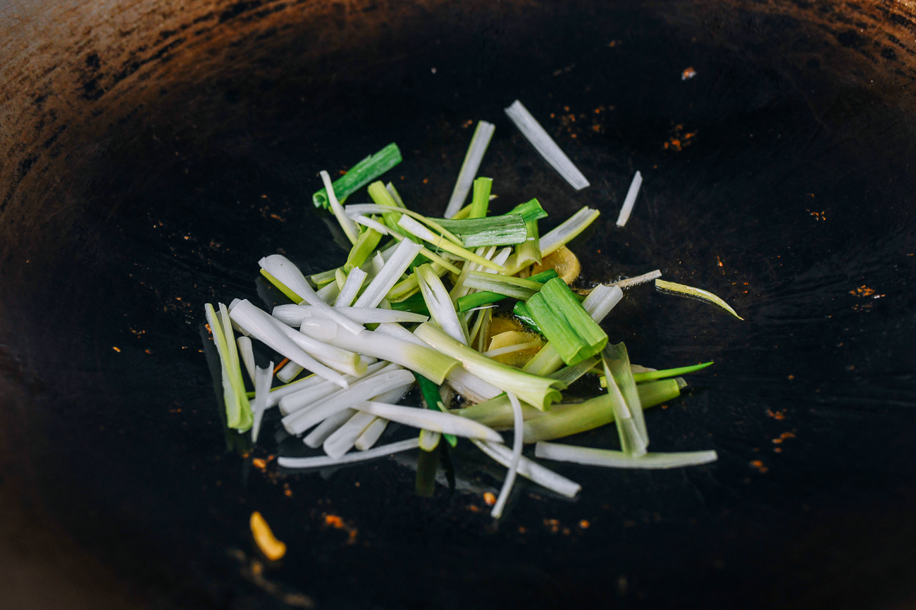 ginger and white parts of scallions in wok