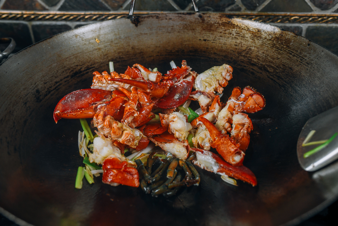 stir-frying lobster pieces in wok