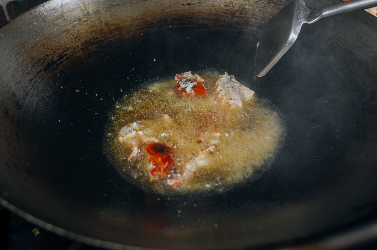 shallow frying lobster pieces in wok