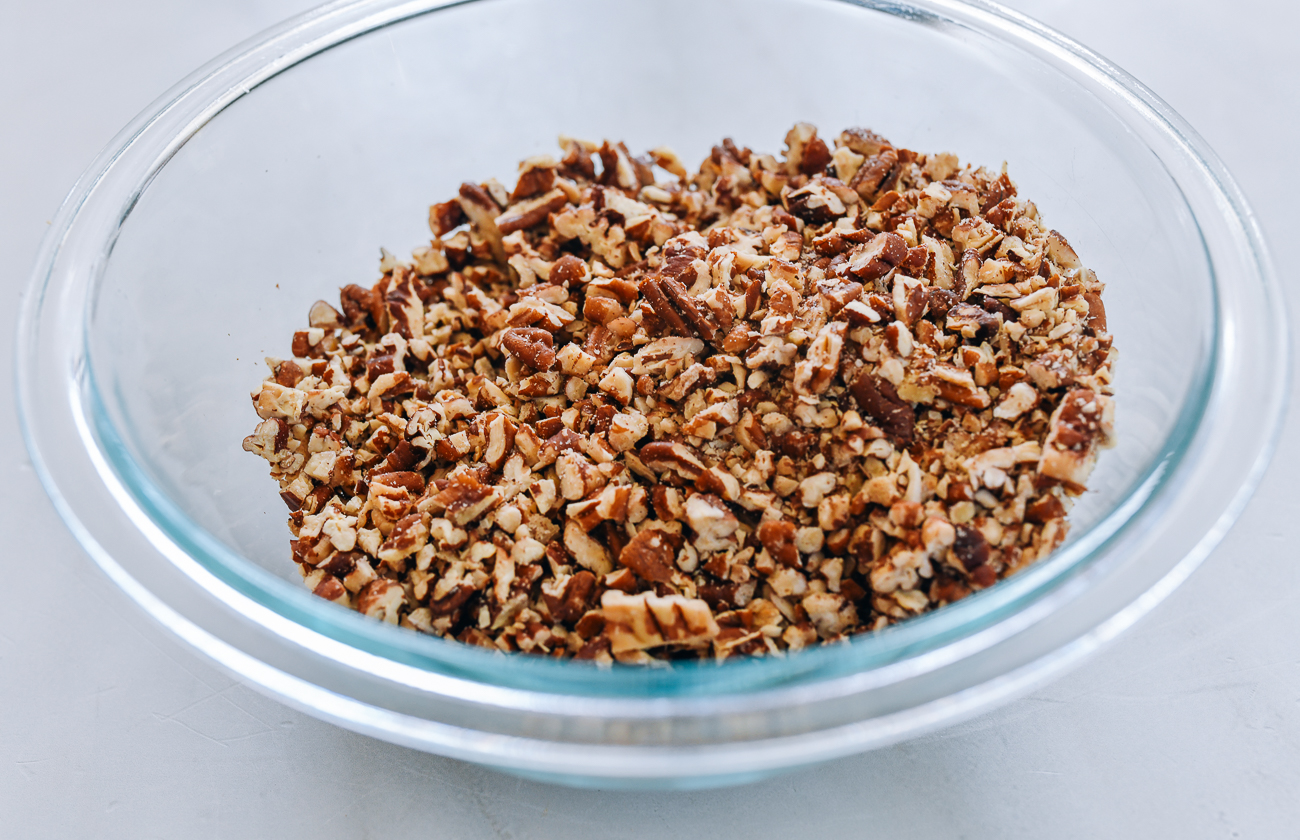 chopped pecans in glass bowl