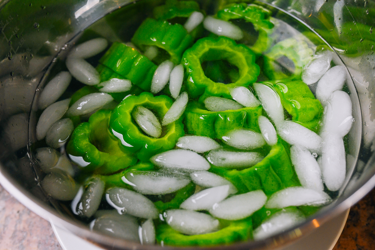 blanched bitter melon rings in ice bath