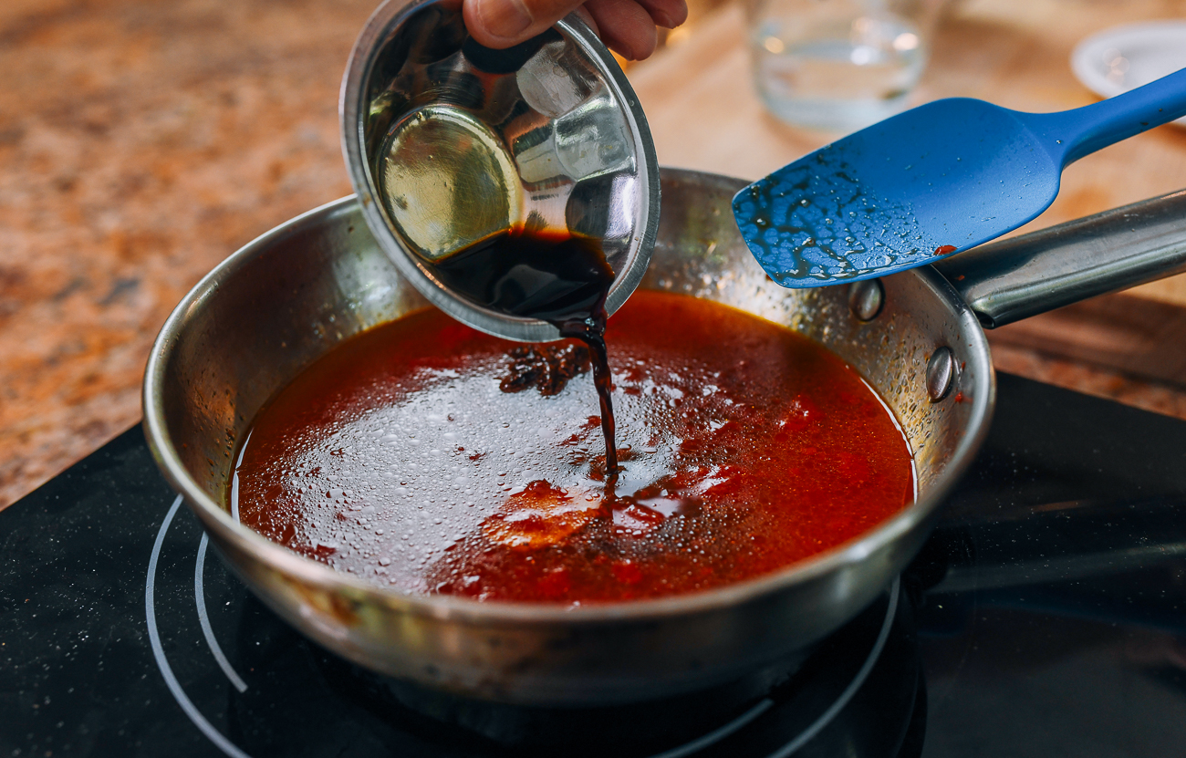 adding soy sauce to sweet and sour sauce