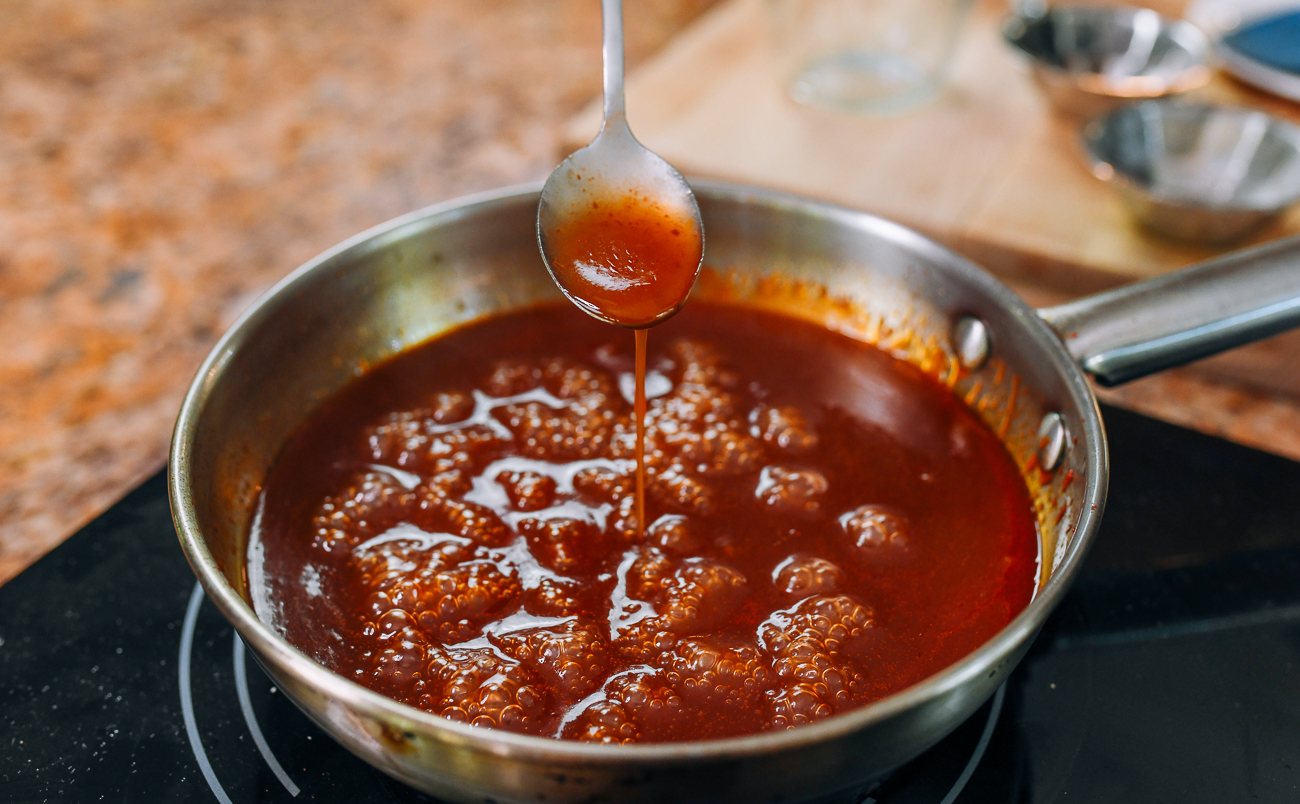 sweet and sour sauce coating a spoon