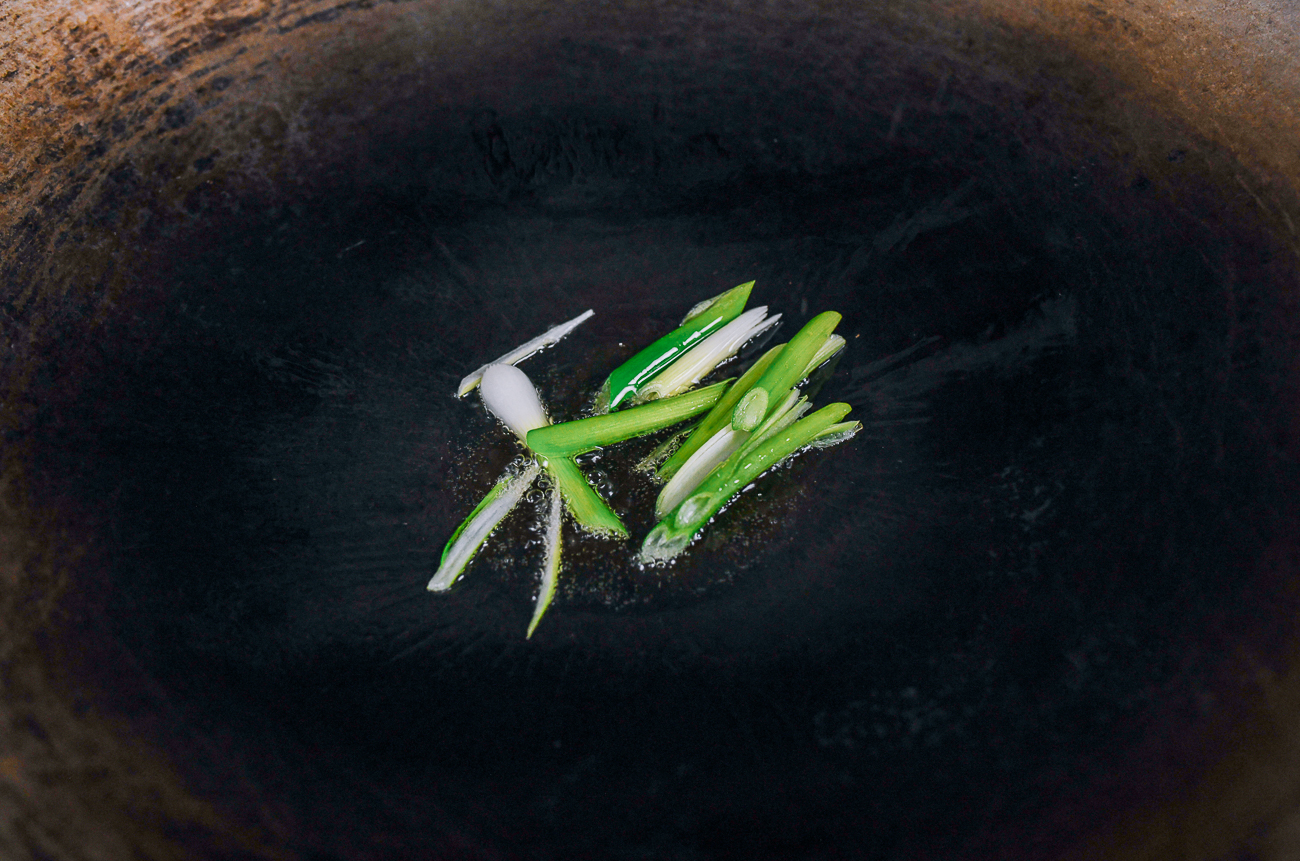 white parts of scallions in wok
