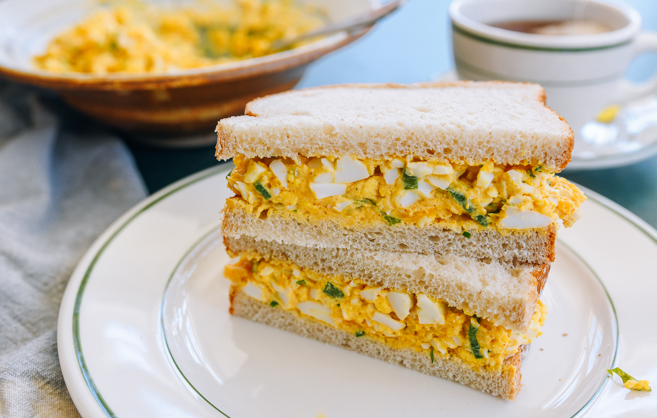 egg salad sandwich halves stacked on each other