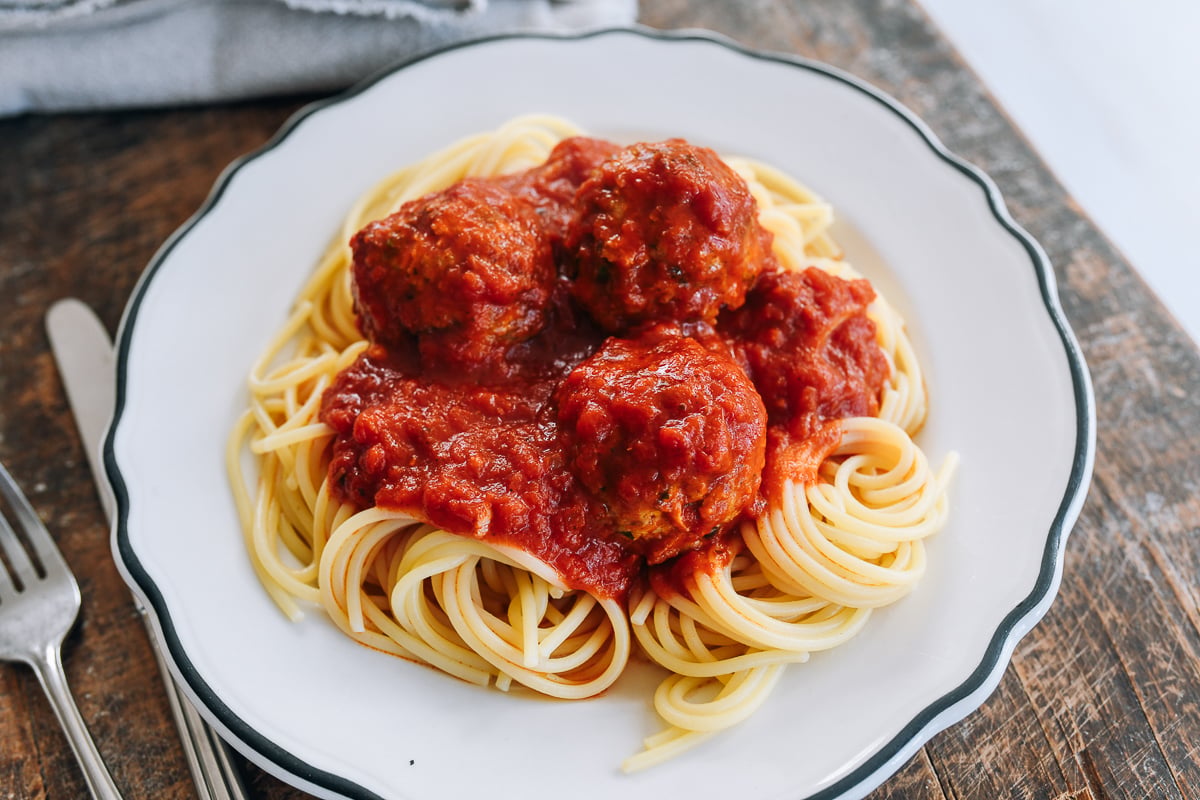 healthy chicken meatballs in marinara over spaghetti