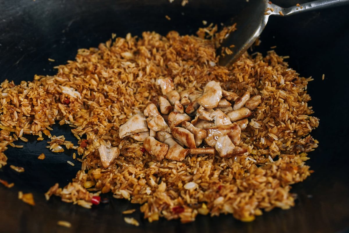 adding chicken to rice