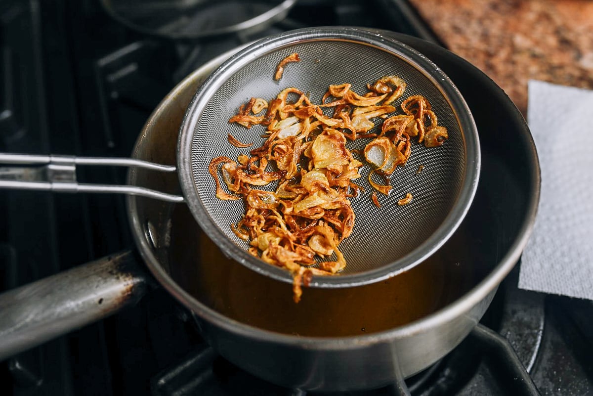pulling fried shallots out of oil