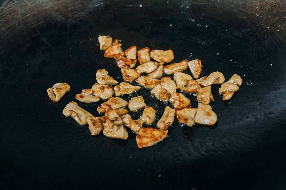 seared chicken pieces in wok