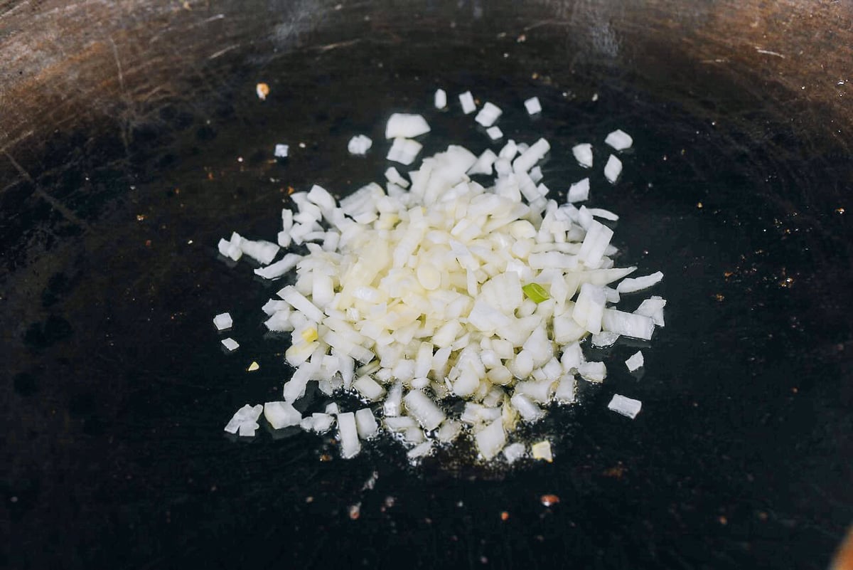 chopped onions in wok