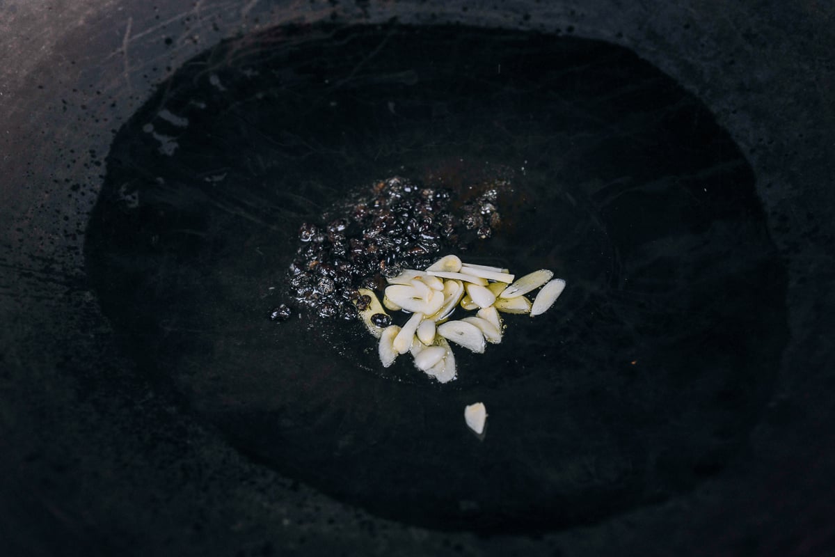 cooking black beans and garlic in wok