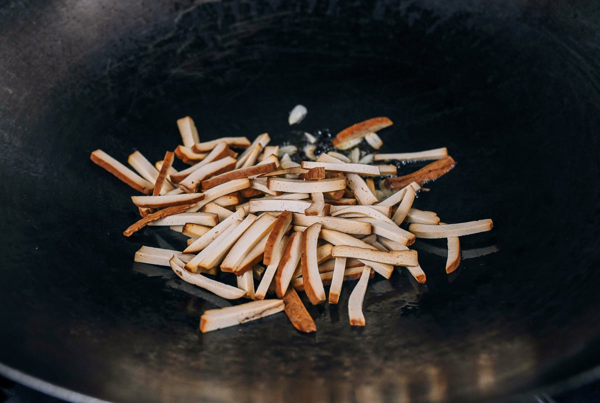 pressed tofu strips in wok