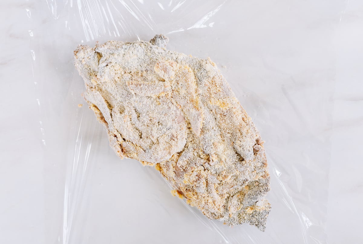 wrapping breaded wor-shu duck in plastic wrap