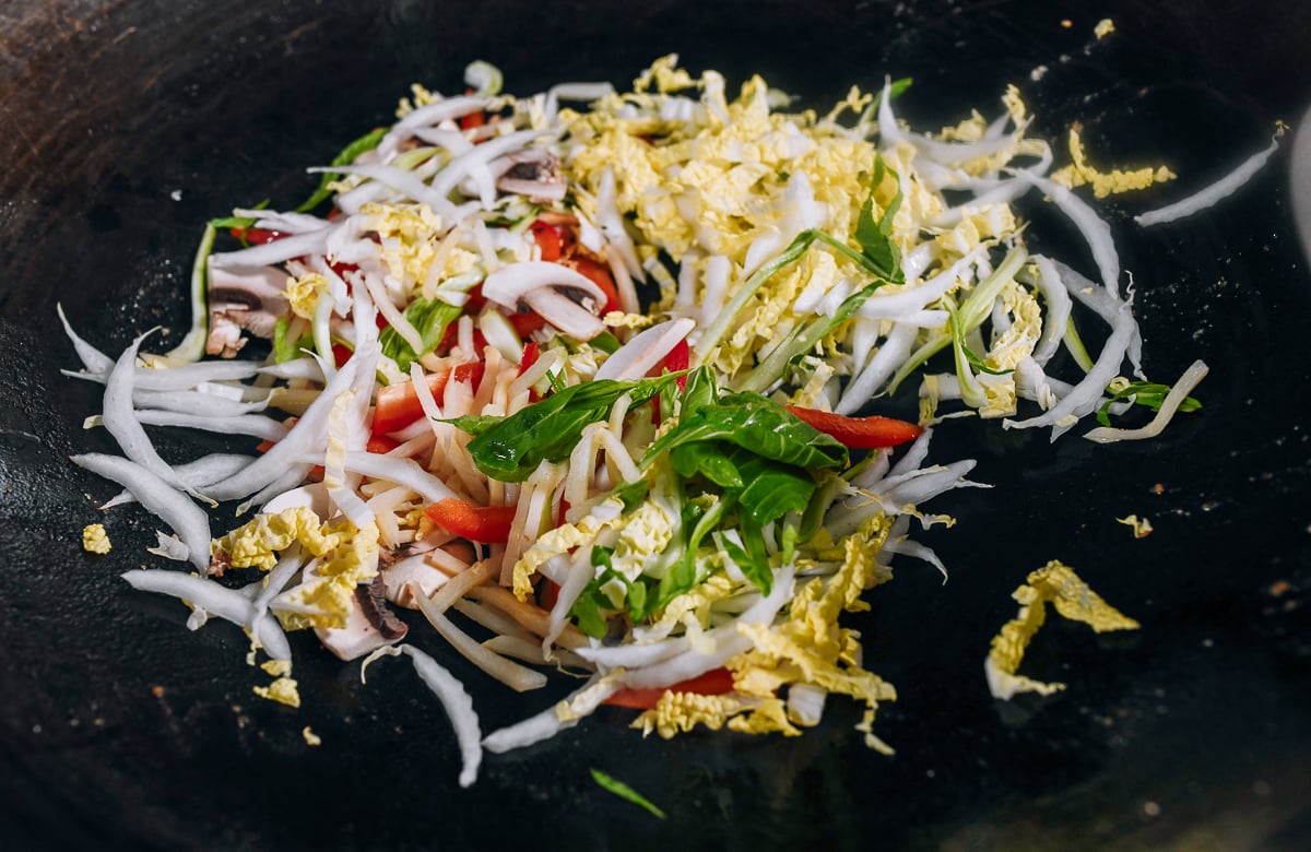 cooking julienned vegetables in wok