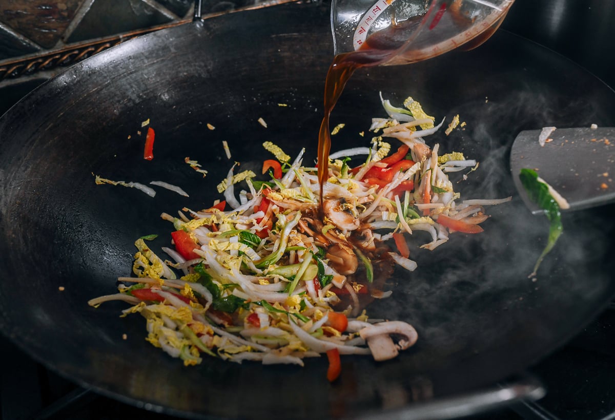adding sauce mixture to vegetables