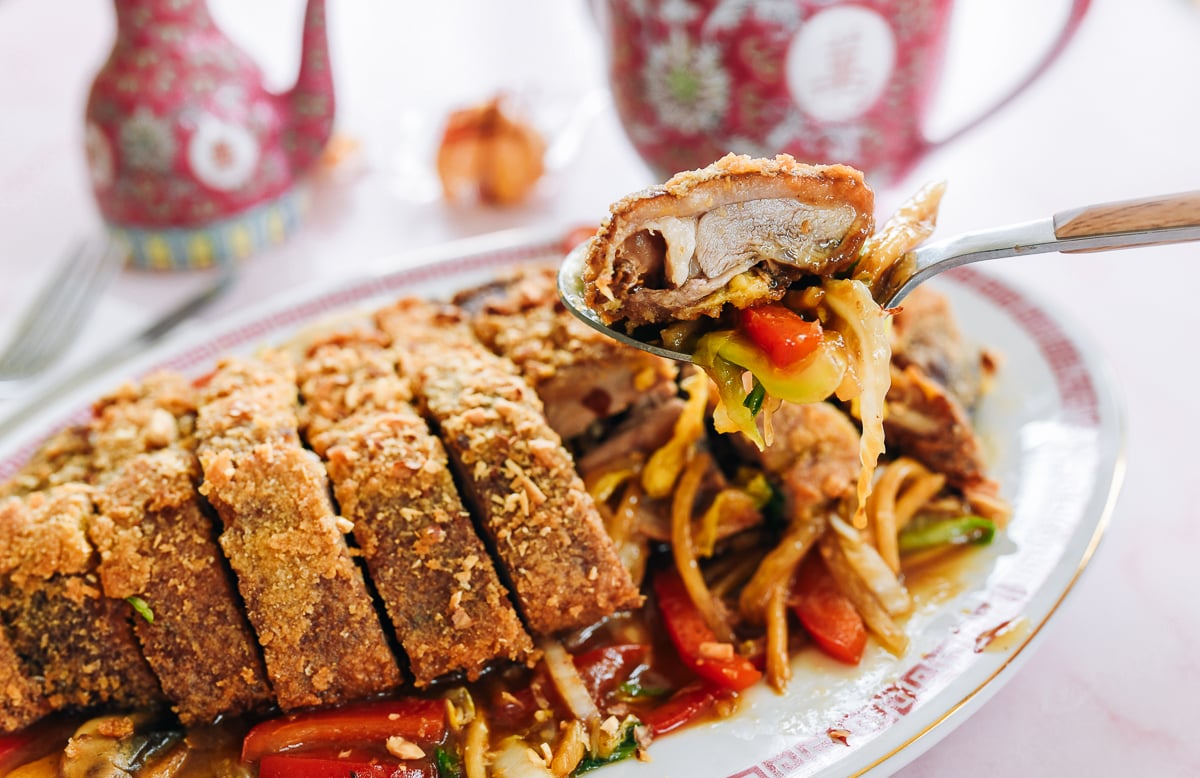 picking up a piece of pressed duck with vegetables