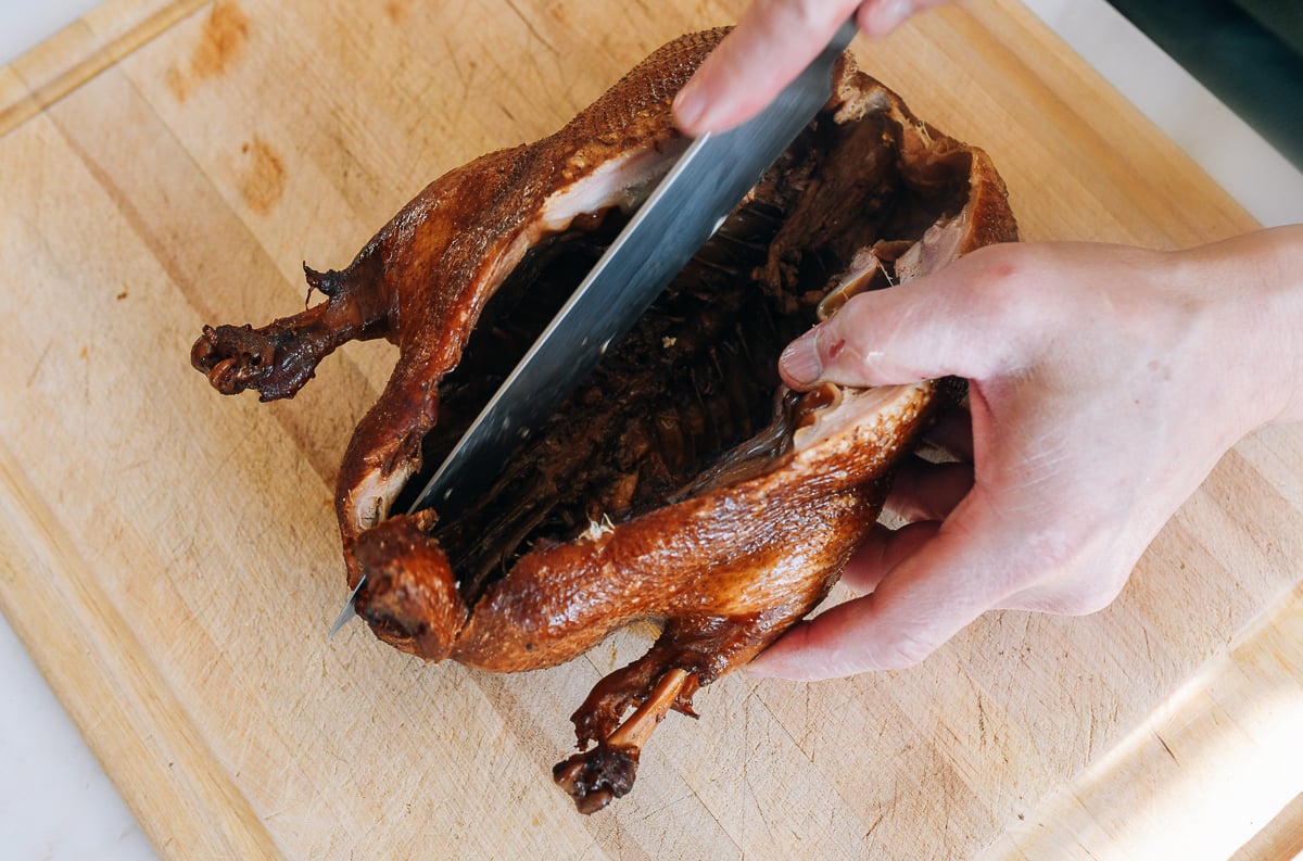 cutting cooked duck to split it open