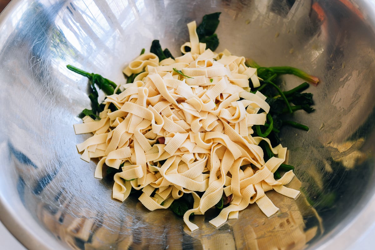 blanched spinach and tofu skin in metal bowl