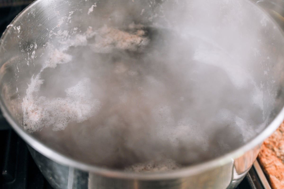 blanching pork bones in pot of water