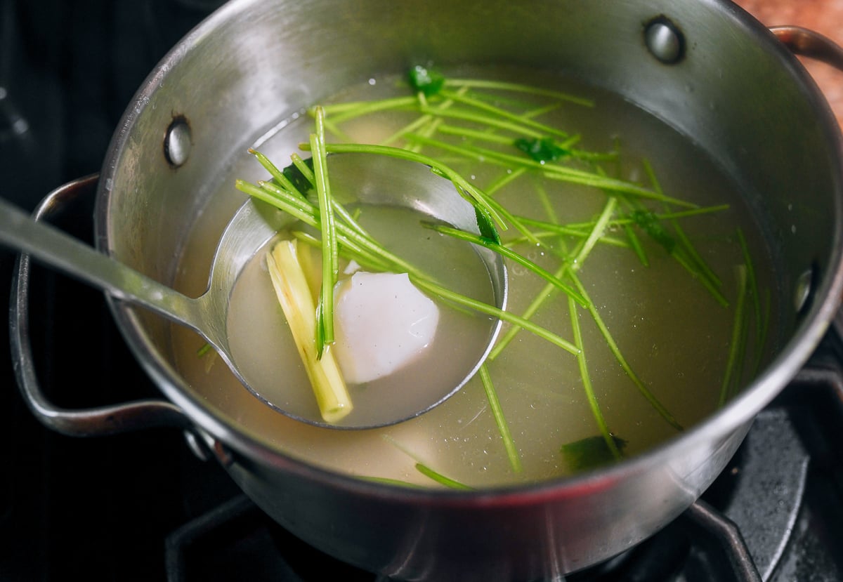 lemongrass, fish ball, and cilantro stems in broth