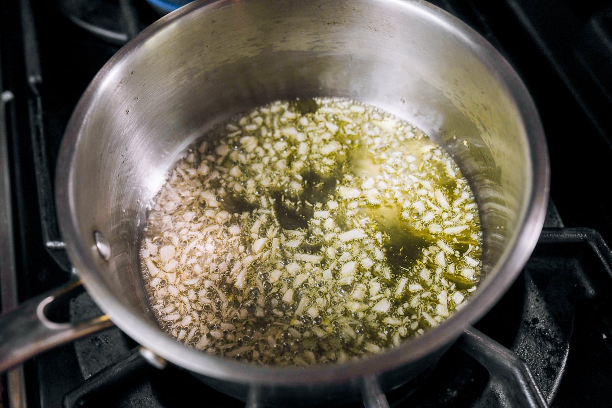 frying finely chopped garlic in oil