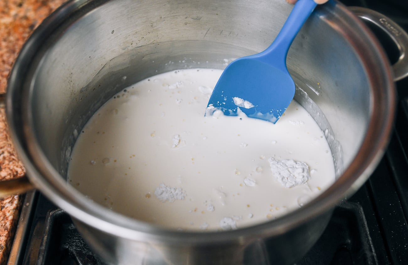 stirring milk pudding mixture