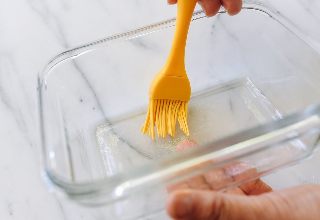 brushing glass container with oil