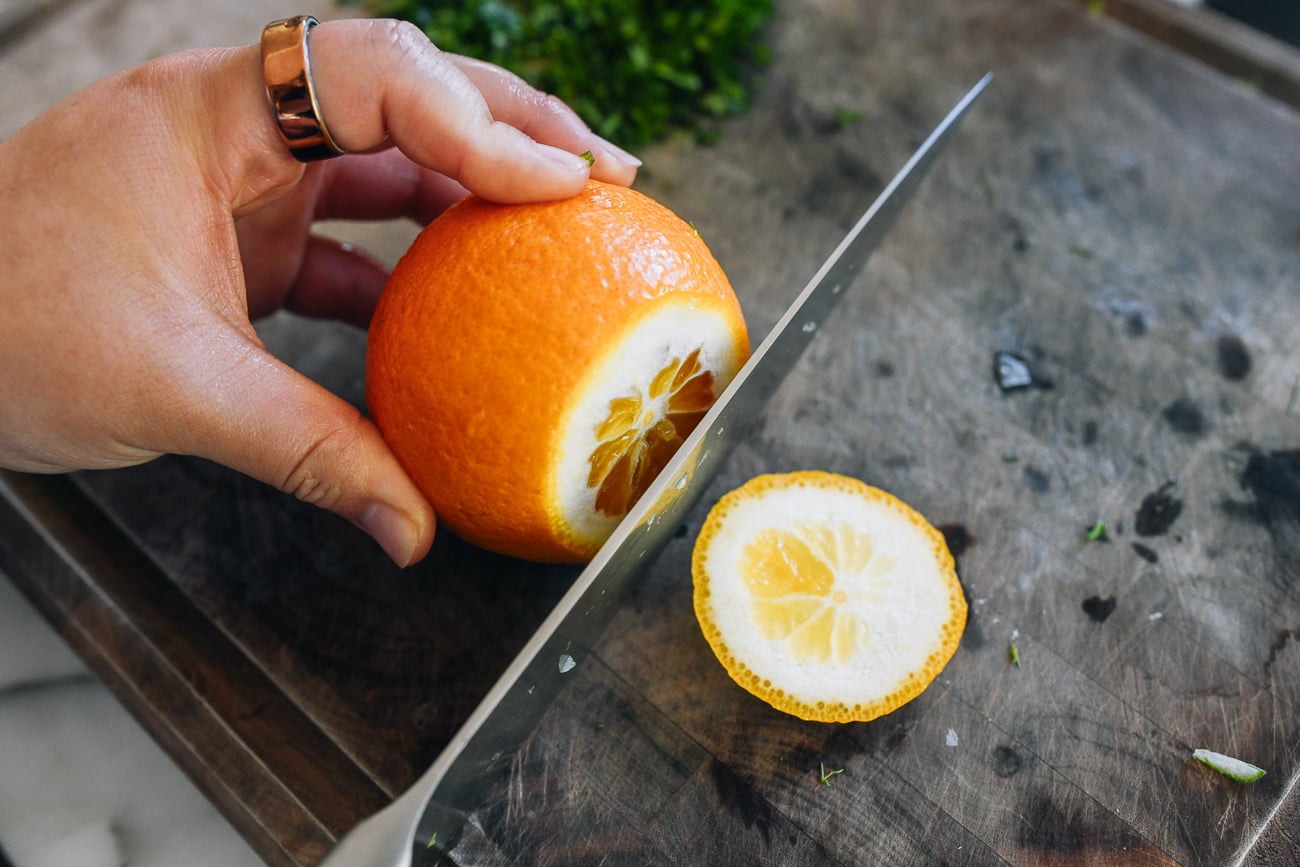 slicing end off of orange
