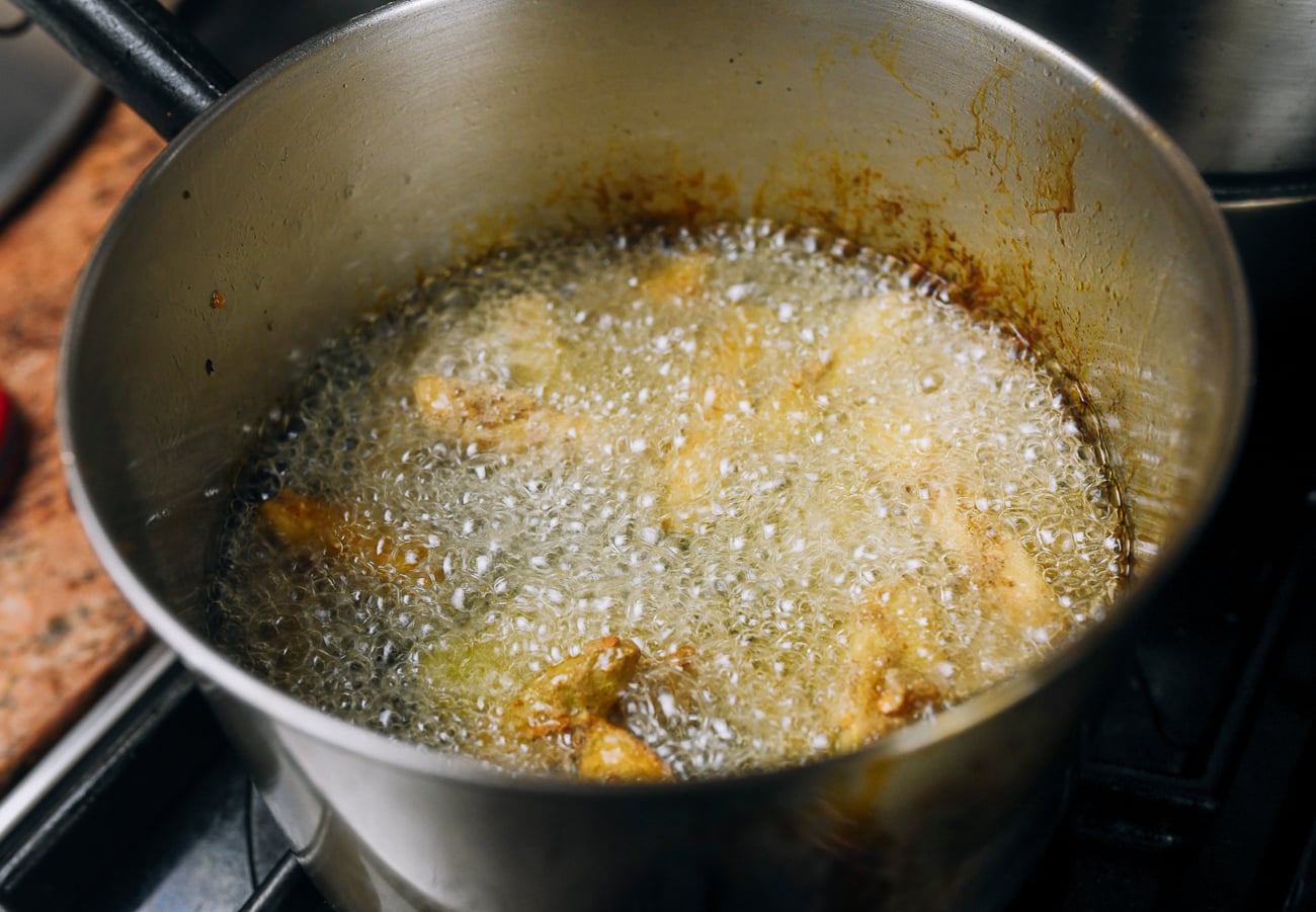 frying eggplant pieces in oil