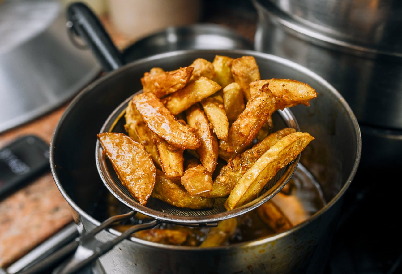 pulling fried eggplant out of oil