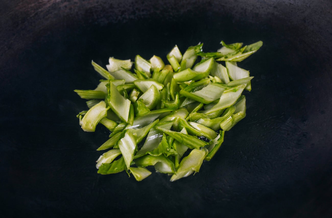 stir-frying mustard green stems in wok