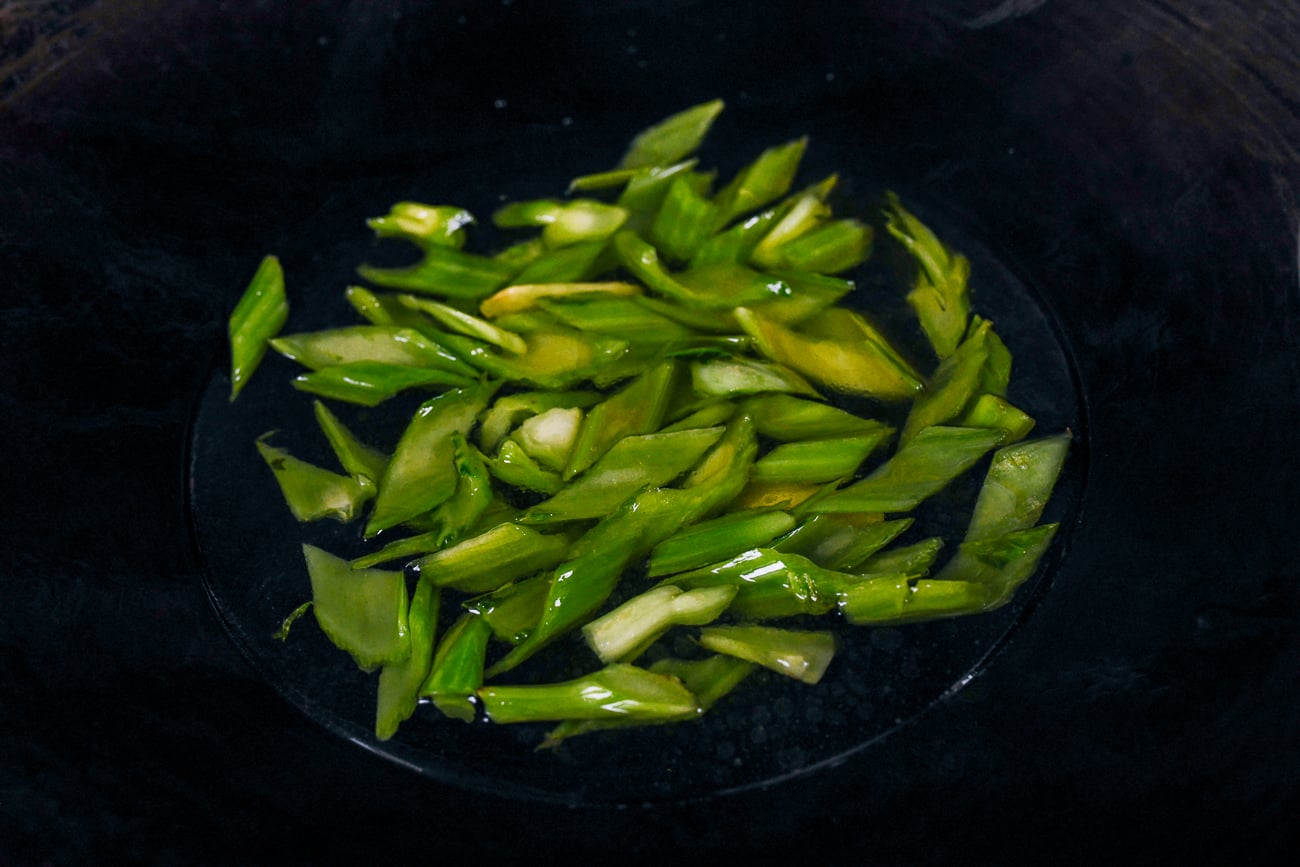 stir-fried mustard green stems in wok