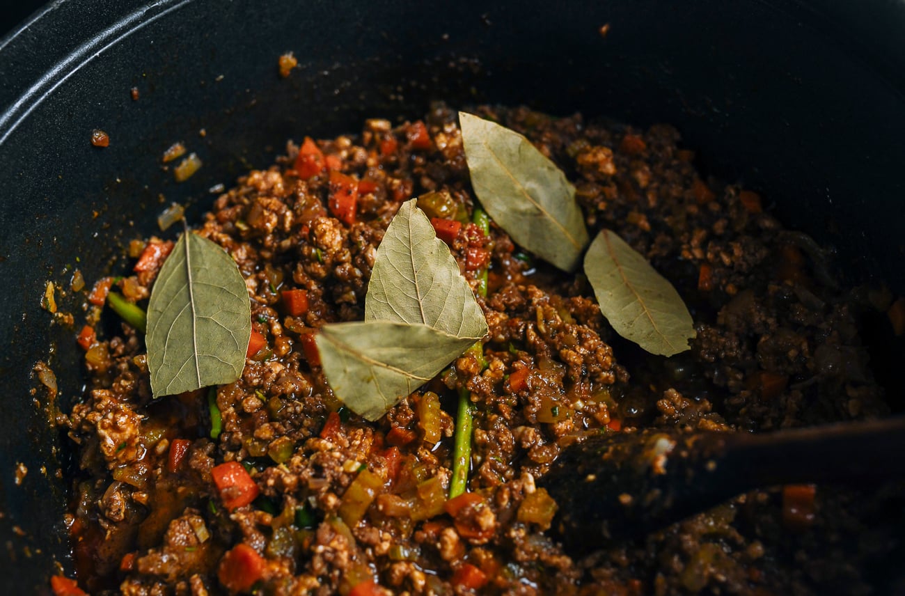 dried bay leaves in meat sauce mixture