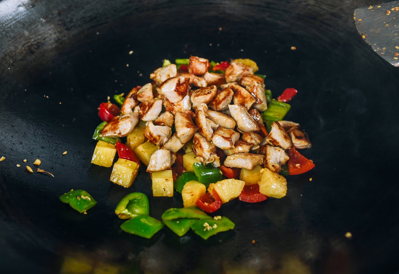 seared chicken added to peppers and pineapple