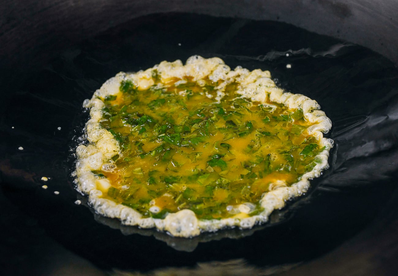 egg and shiso mixture added to oil in wok