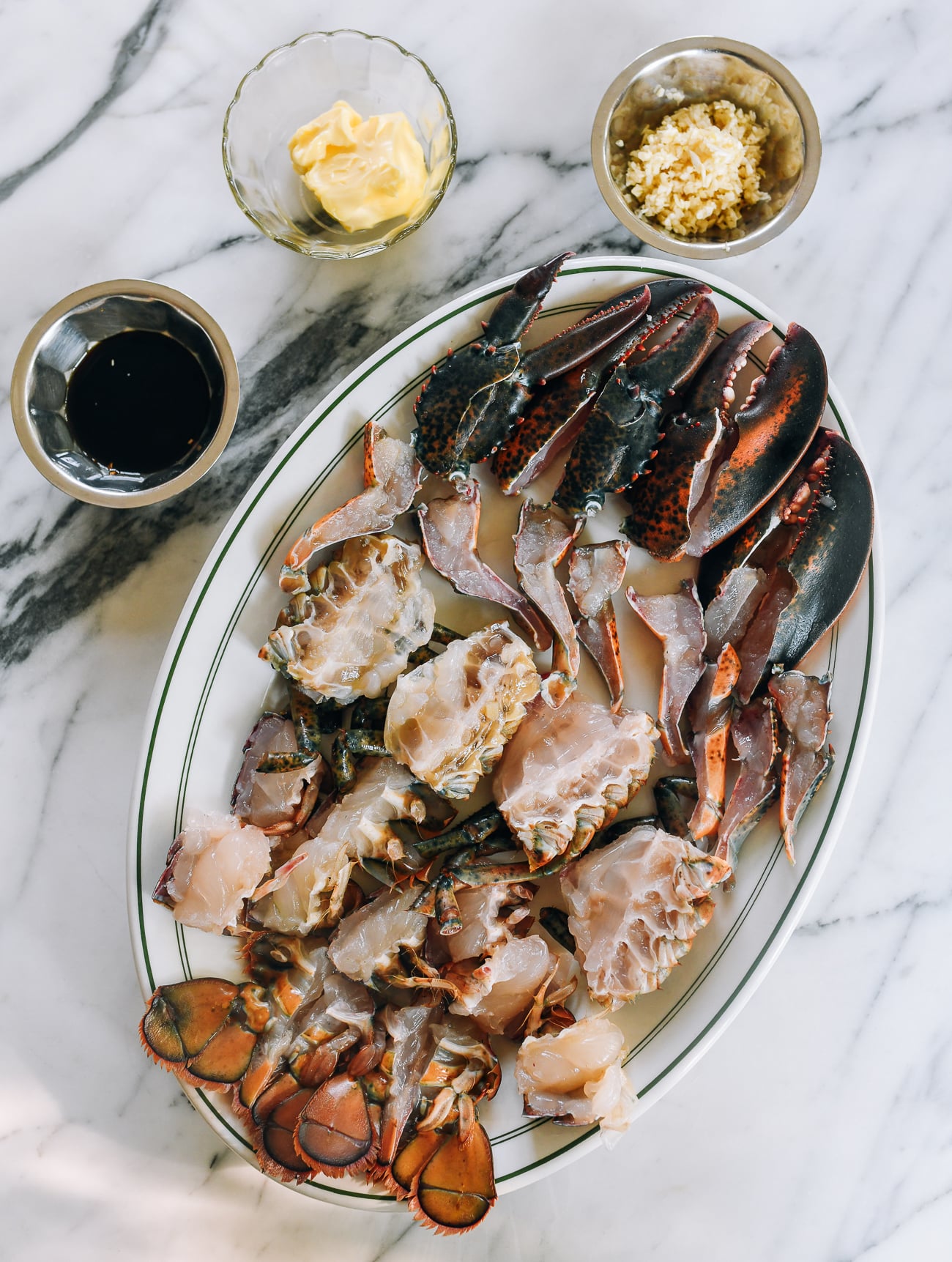 lobster pieces on platter with sauce ingredients
