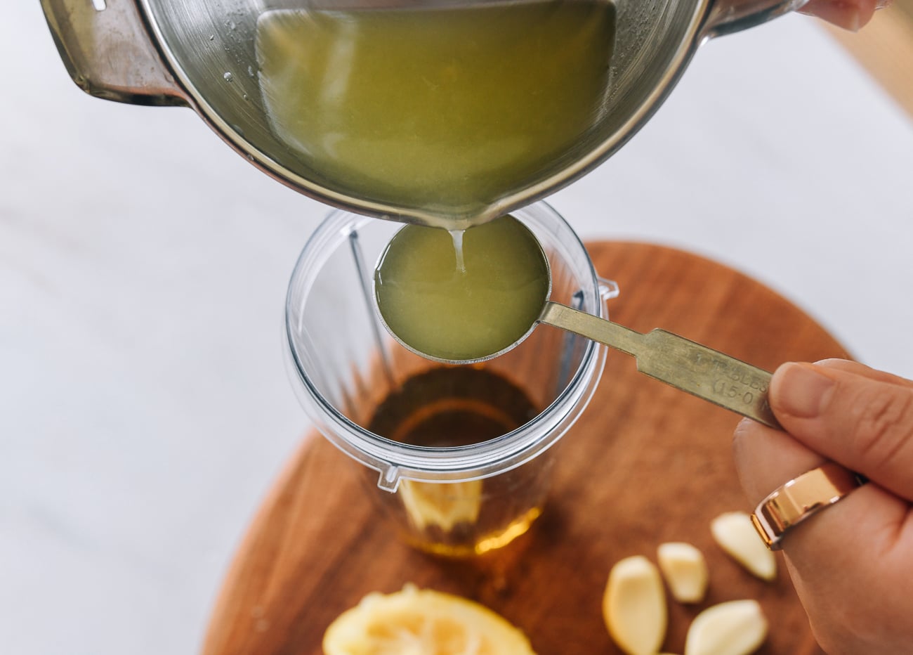 pouring lemon juice into tablespoon measure