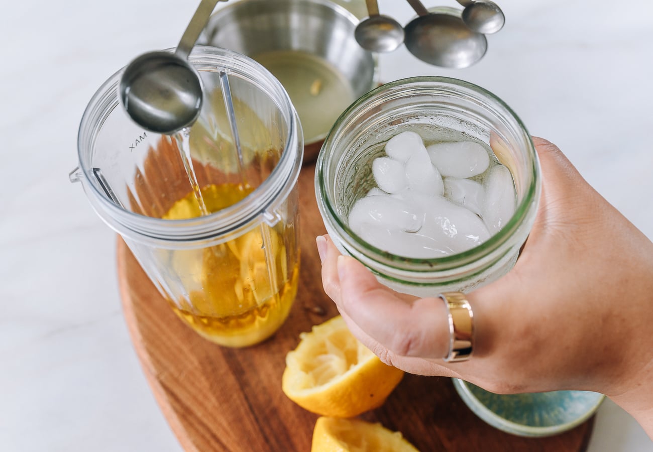 adding ice water to blender with oil