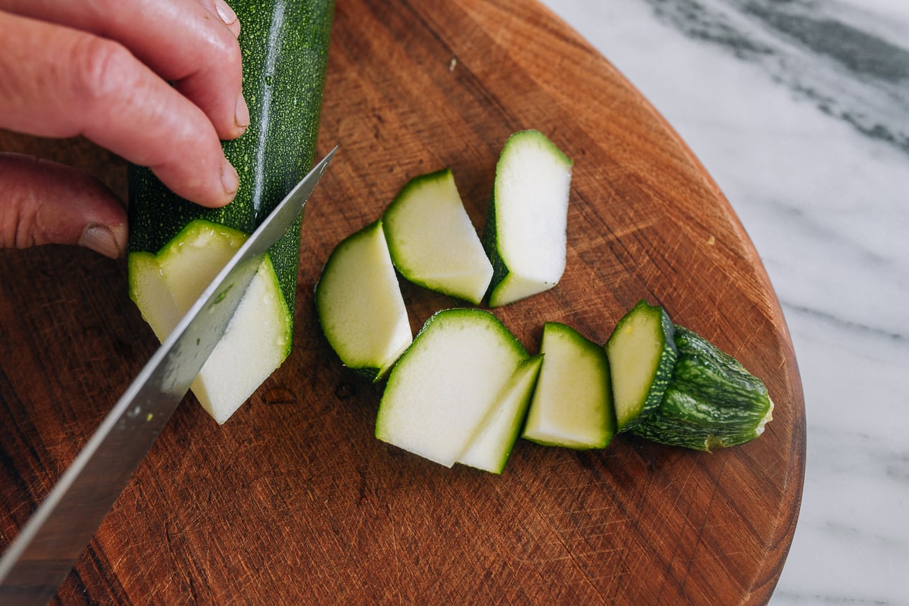 cutting zucchini into triangular chunks