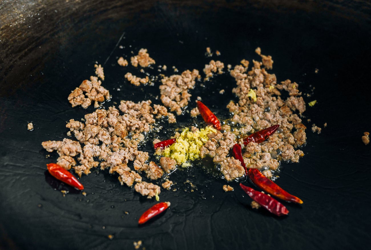 ginger and chilies added to ground pork