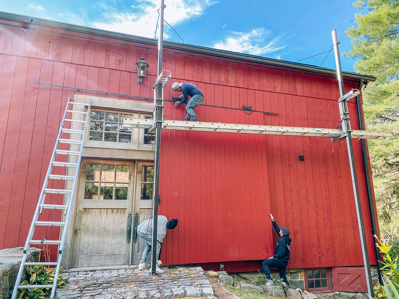 completing siding on barn