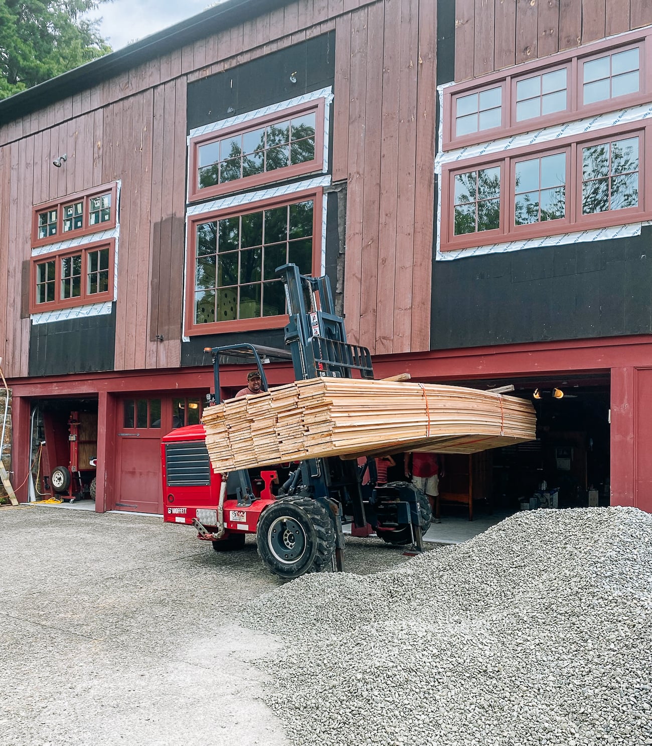 bringing in cedar planks for barn siding