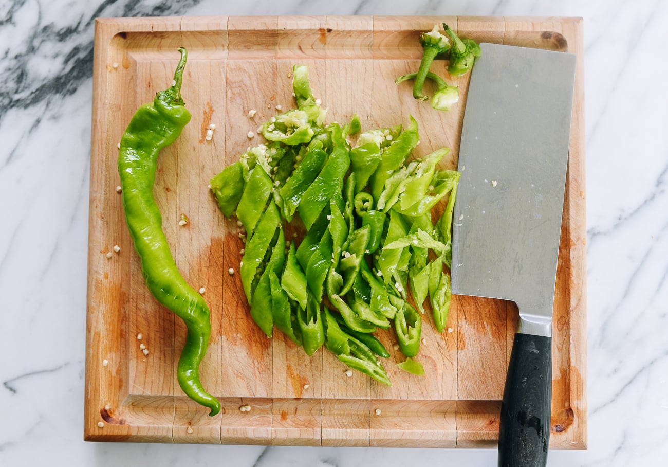 sliced long hot green peppers on cutting board